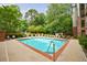 Community pool surrounded by lounge chairs and lush greenery for relaxation at 50 Biscayne Dr # 2106, Atlanta, GA 30309