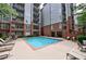 Community pool with lounge chairs, tables and chairs in a courtyard setting at 50 Biscayne Dr # 2106, Atlanta, GA 30309