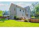 A spacious backyard with a patio, lush lawn, wood fence, and stairs leading to a higher level at 940 Longley Nw Ave, Atlanta, GA 30318