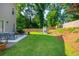Beautiful backyard with a spacious patio, lush lawn, and a play area for Gathering fun at 940 Longley Nw Ave, Atlanta, GA 30318