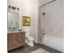 Bathroom featuring wood vanity, stylish mirror, a combination shower and tub, and neutral color scheme at 940 Longley Nw Ave, Atlanta, GA 30318