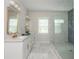 Bright bathroom featuring double sinks, modern fixtures, and a glass-enclosed shower with marble tile at 940 Longley Nw Ave, Atlanta, GA 30318