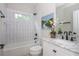 Stylish bathroom with a tiled shower, modern fixtures, and a sleek vanity with marble countertop at 940 Longley Nw Ave, Atlanta, GA 30318
