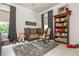 Comfortable Bedroom with a wooden crib, rocking chair, and a bookshelf filled with books and toys at 940 Longley Nw Ave, Atlanta, GA 30318