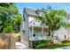 Charming home with a two-story porch, well-maintained landscaping, and a cozy front entrance at 940 Longley Nw Ave, Atlanta, GA 30318