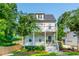 Charming two-story home with a gray exterior, inviting front porch, and beautifully landscaped front yard at 940 Longley Nw Ave, Atlanta, GA 30318