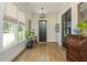 Charming entryway with hardwood floors, a decorative desk, and large windows providing ample natural light at 940 Longley Nw Ave, Atlanta, GA 30318