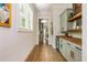 Hallway featuring hardwood floors, a beverage fridge and stylish cabinets with wooden counter at 940 Longley Nw Ave, Atlanta, GA 30318