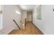 Hallway with hardwood floors, natural light, and access to stairs, adding to its aesthetic appeal at 940 Longley Nw Ave, Atlanta, GA 30318