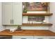 Hallway nook with a dark stained butcher block countertop, open shelving, and charming decor at 940 Longley Nw Ave, Atlanta, GA 30318