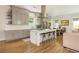 Modern kitchen with stainless steel appliances, a large island with seating, and hardwood floors at 940 Longley Nw Ave, Atlanta, GA 30318