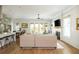 Bright and airy living room with a fireplace, large windows, and a view of the kitchen at 940 Longley Nw Ave, Atlanta, GA 30318