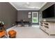 Spacious living room with dark walls, white trim, desk, and ample space for seating and entertainment at 940 Longley Nw Ave, Atlanta, GA 30318