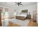 Main bedroom featuring a king bed, ceiling fan, and hardwood floors, with a door to the exterior at 940 Longley Nw Ave, Atlanta, GA 30318