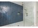 Shower with blue herringbone tile accent wall, rain shower head, and frameless glass enclosure at 940 Longley Nw Ave, Atlanta, GA 30318