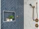 Luxurious shower featuring blue herringbone tile and a convenient built-in niche for bath essentials at 940 Longley Nw Ave, Atlanta, GA 30318
