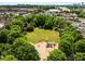 An aerial view of a lush park with a playground and pond in a neighborhood setting at 980 Faith Se Ave, Atlanta, GA 30316