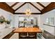 Dining area showcases an elegant light fixture, hardwood floors and seamlessly connects to the modern kitchen at 980 Faith Se Ave, Atlanta, GA 30316
