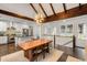 Open dining area adjacent to kitchen featuring vaulted ceilings with exposed beams and an elegant light fixture at 980 Faith Se Ave, Atlanta, GA 30316