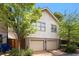 Two-story home exterior with a two-car garage with trees and lawn in the front at 980 Faith Se Ave, Atlanta, GA 30316