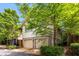 Two-story home with a two-car garage on the ground floor and siding on the second floor surrounded by trees at 980 Faith Se Ave, Atlanta, GA 30316