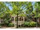 Charming home with a covered front porch, decorative railings, lush trees, and a welcoming walkway at 980 Faith Se Ave, Atlanta, GA 30316