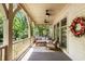 Relaxing front porch with neutral decor, a beautiful wreath, and comfortable outdoor seating at 980 Faith Se Ave, Atlanta, GA 30316