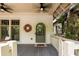 Inviting front porch featuring neutral decor, a beautiful wreath, and stylish outdoor furniture at 980 Faith Se Ave, Atlanta, GA 30316