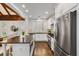 Modern kitchen with white cabinets, stainless steel appliances and an island with seating at 980 Faith Se Ave, Atlanta, GA 30316