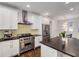 Bright kitchen featuring white cabinets, stainless steel appliances, and a center island with a dark countertop at 980 Faith Se Ave, Atlanta, GA 30316