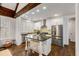Modern kitchen with white cabinets, stainless steel appliances, a kitchen island and hardwood floors at 980 Faith Se Ave, Atlanta, GA 30316