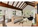Spacious living room featuring vaulted ceilings with exposed beams, hardwood floors and multiple seating areas at 980 Faith Se Ave, Atlanta, GA 30316