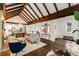 Open-concept living room with vaulted ceilings, exposed beams, and a seamless flow to the adjacent kitchen and dining area at 980 Faith Se Ave, Atlanta, GA 30316