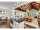 Open concept featuring the living, dining, and kitchen areas, with exposed beams and hardwood floors at 980 Faith Se Ave, Atlanta, GA 30316