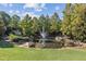 Scenic pond with a fountain and a small bridge surrounded by trees and lush greenery at 980 Faith Se Ave, Atlanta, GA 30316