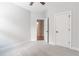 A bright bedroom features neutral walls, carpet, and trim, a ceiling fan, and access to an ensuite bathroom at 1964 Attell Way, Decatur, GA 30033