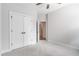 A bright bedroom features neutral walls, carpet, and trim, a ceiling fan, and a large closet at 1964 Attell Way, Decatur, GA 30033