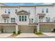 Exterior view of townhomes, showcasing garages, balconies, and coordinated design elements at 1964 Attell Way, Decatur, GA 30033