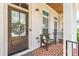 Charming front porch with brick floor, bench seating, and decorative wreath at 1964 Attell Way, Decatur, GA 30033