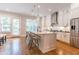 Modern kitchen with white cabinets, stainless steel appliances, and a large island with seating at 1964 Attell Way, Decatur, GA 30033
