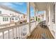 View from a covered porch, including wood flooring, white posts, and a view of the neighborhood at 1964 Attell Way, Decatur, GA 30033