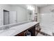 Bathroom featuring a double sink vanity with a large mirror and a shower-tub combination at 5525 Sable Way, Atlanta, GA 30349