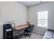 This bedroom features neutral walls, plush carpeting, and a large window with natural light at 5525 Sable Way, Atlanta, GA 30349