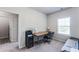 This bedroom features neutral walls, plush carpeting, and a large window with natural light at 5525 Sable Way, Atlanta, GA 30349