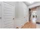Bright hallway with hardwood floors, white trim, and multiple doors leading to different areas of the house at 5525 Sable Way, Atlanta, GA 30349