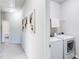 Upstairs hallway featuring a laundry room with a white washer and dryer at 5525 Sable Way, Atlanta, GA 30349