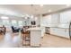 Open-concept kitchen with white cabinets, granite countertops, and a breakfast bar overlooking the living area at 5525 Sable Way, Atlanta, GA 30349