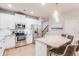 Stylish kitchen featuring stainless steel appliances, granite counters, and an island with bar seating, adjacent to the stairs at 5525 Sable Way, Atlanta, GA 30349