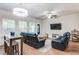 Comfortable living room featuring hardwood floors, a ceiling fan, and a TV, perfect for relaxation and entertainment at 5525 Sable Way, Atlanta, GA 30349