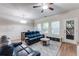 Cozy living room featuring hardwood floors, comfortable seating, and natural light from the window at 5525 Sable Way, Atlanta, GA 30349